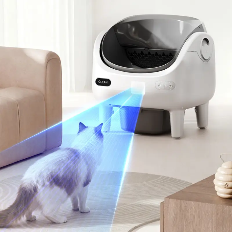Open-style smart self-clean cat litter box with blue laser safety monitoring detecting a cat approaching in a bright modern home
