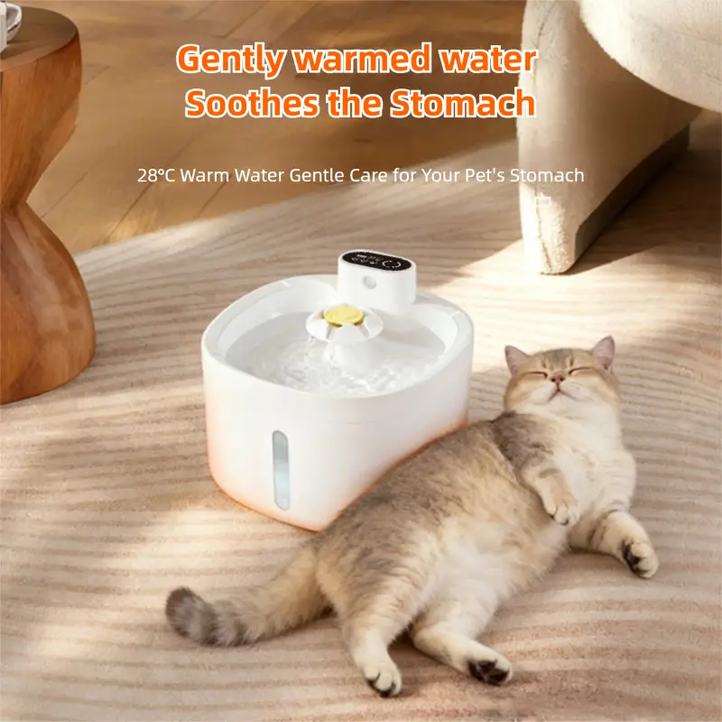 White heated pet water fountain with 28°C warm water, cat relaxing beside it.