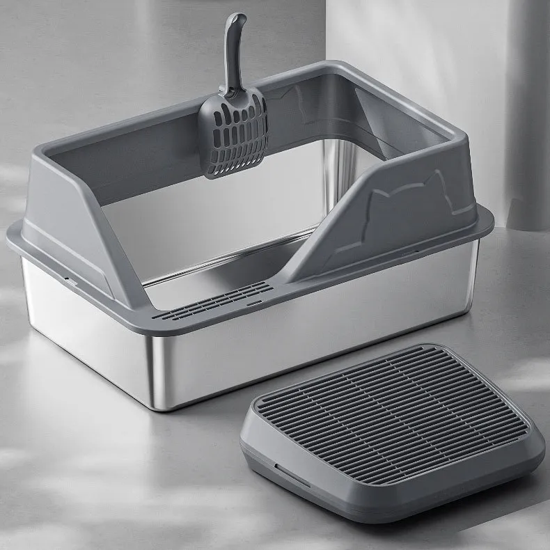 Stainless steel cat litter box set with gray rim, litter scoop, and anti-tracking mat on a polished surface