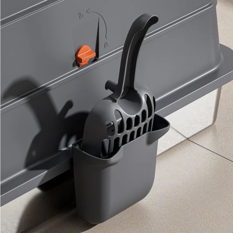 Close-up of stainless steel cat litter box with litter scoop and storage holder for easy cleaning